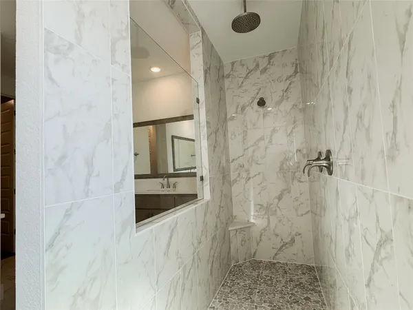 a bathroom with a granite countertop shower