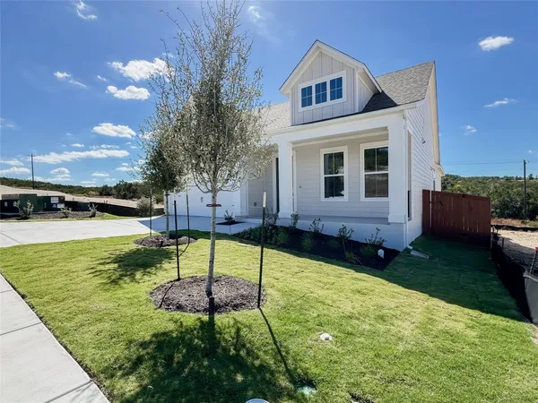 a view of an house with backyard space and garden