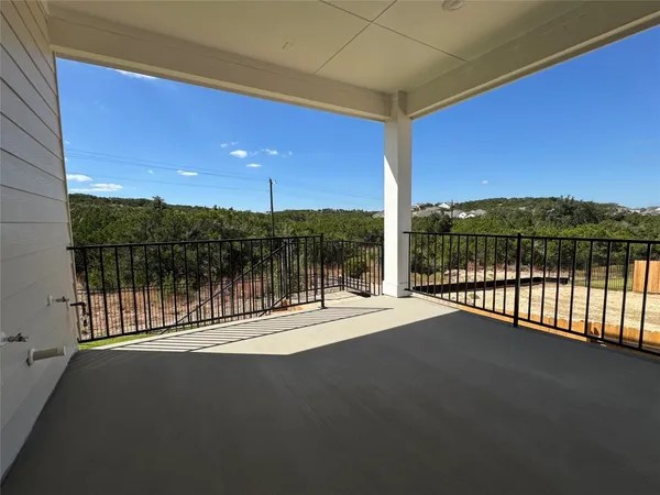 a view of balcony with floor to ceiling windows with wooden fence