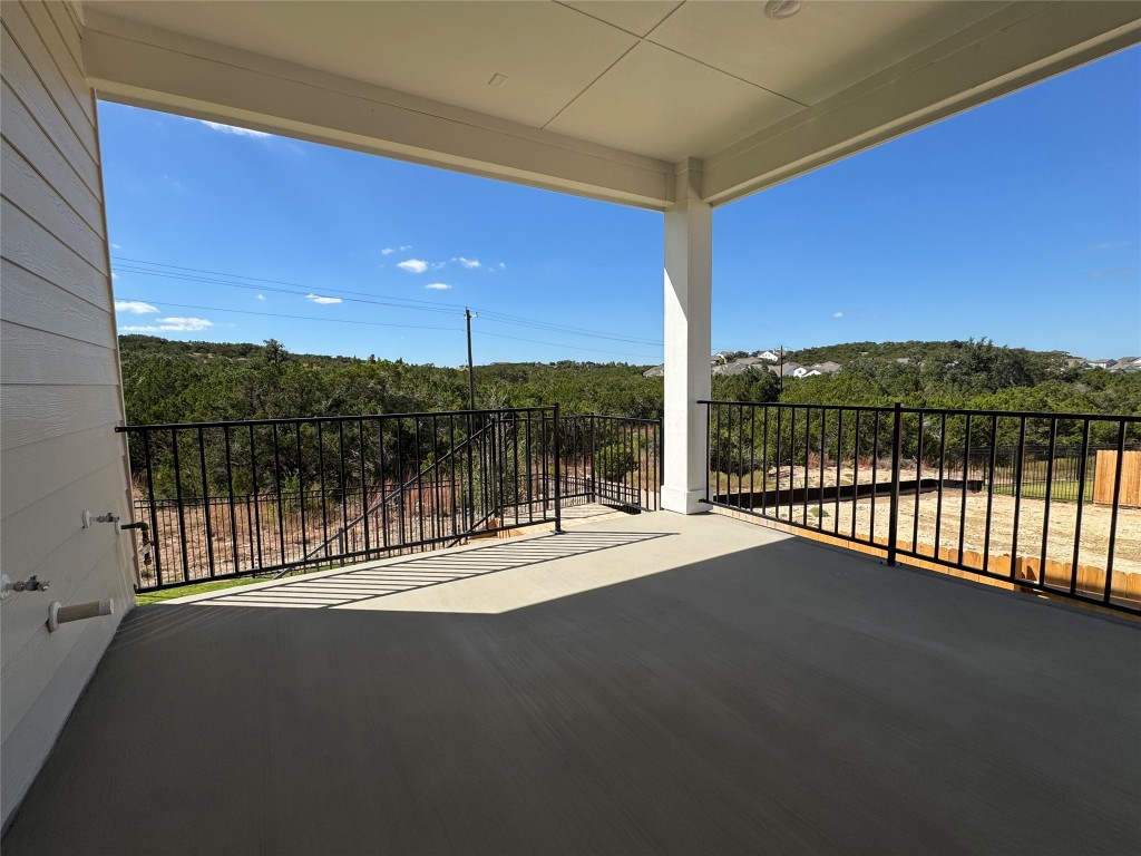 712 Iron Willow Loop Dripping Springs, TX 78620 - Photo 22 of 30 a view of balcony with floor to ceiling windows with wooden fence