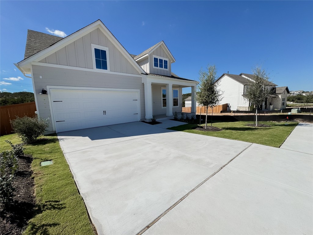 712 Iron Willow Loop Dripping Springs, TX 78620 - Photo 26 of 30 a front view of a house with a yard and garage