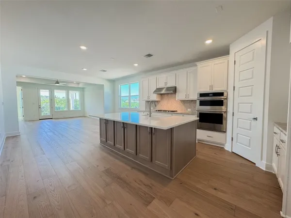 a kitchen with stainless steel appliances a refrigerator and wooden cabinets