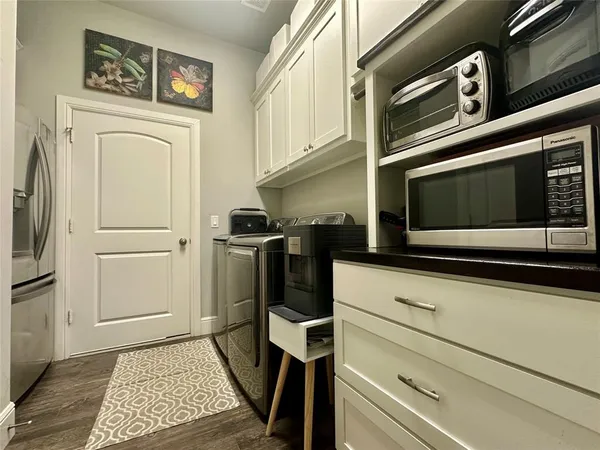a kitchen with stainless steel appliances a stove a microwave and a refrigerator
