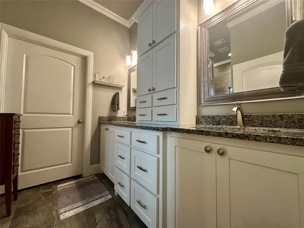 a kitchen with white cabinets and refrigerator