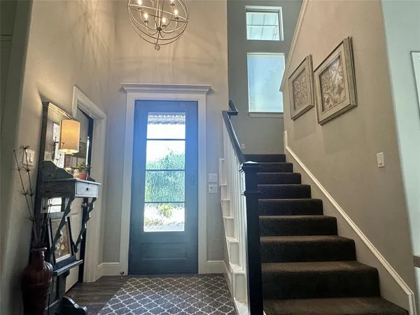 a view of an entryway with wooden floor
