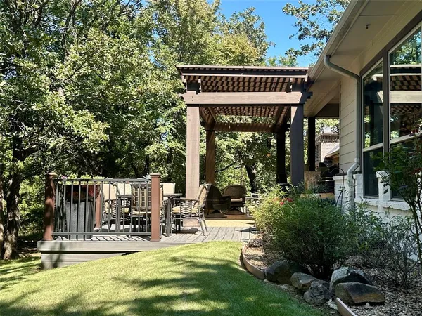 a view of a house with garden and sitting area