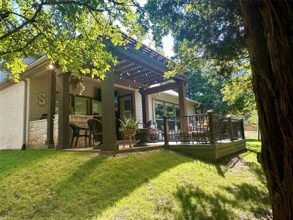 a view of a house with backyard porch and sitting area