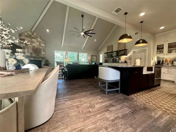 a kitchen with a sink a counter space appliances and a dining table