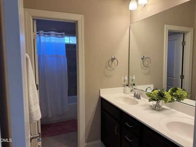 a view of a hallway with wooden floor and entryway