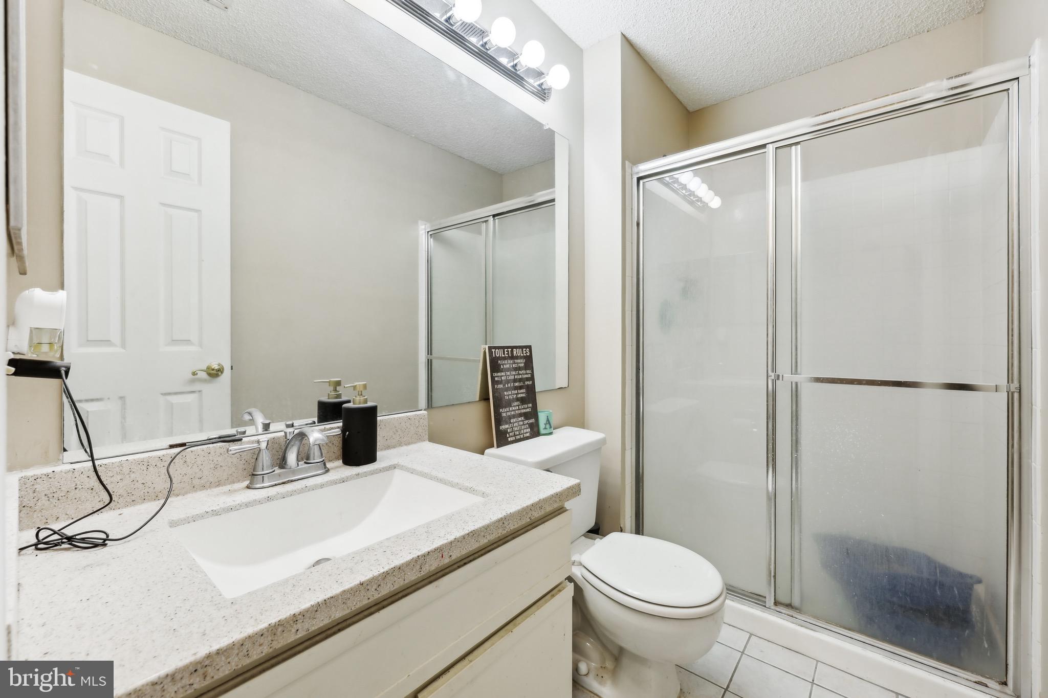 3805 Green Ridge Court, Unit 201 Fairfax, VA 22033 - Photo 12 of 25 a bathroom with a sink toilet and shower
