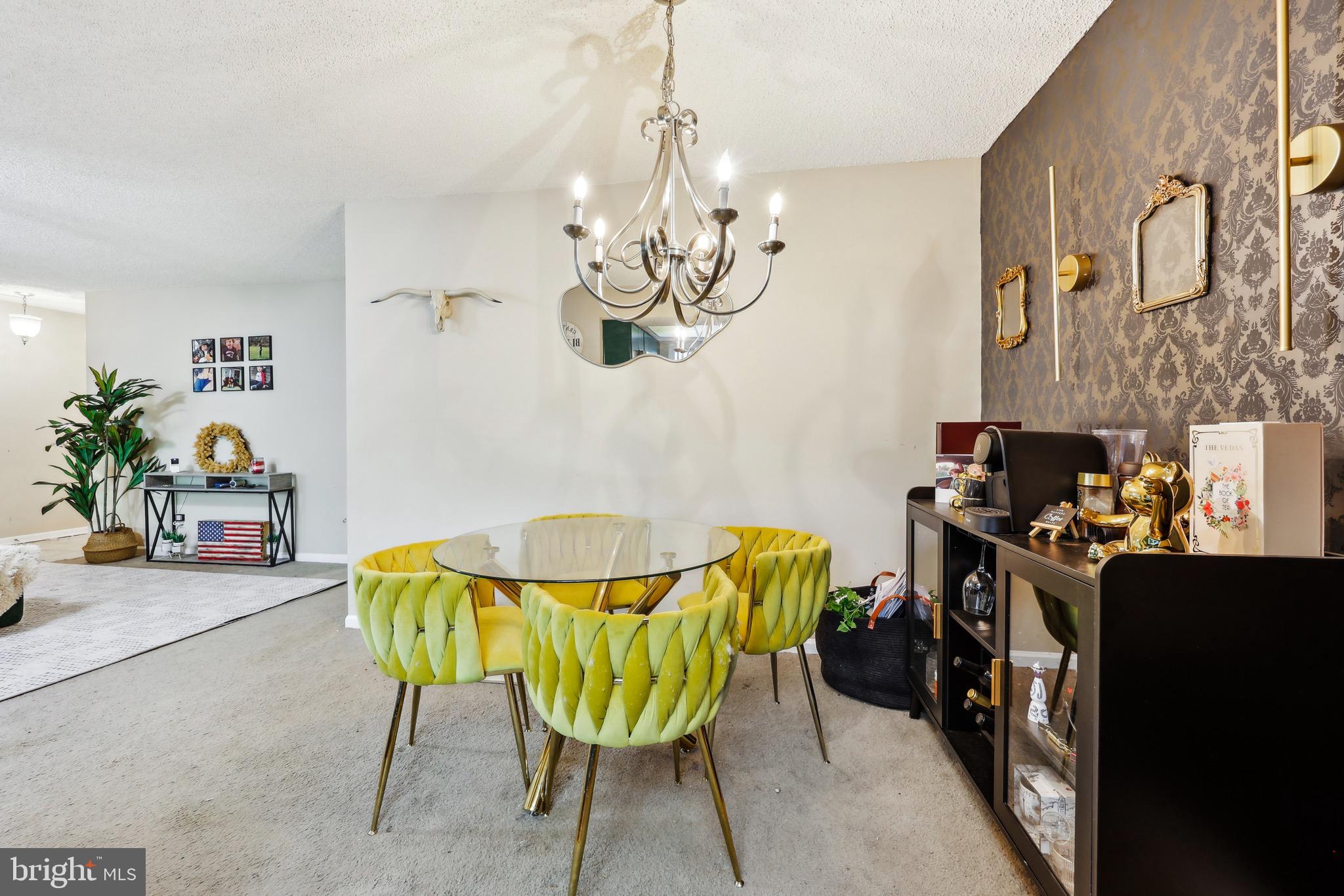 3805 Green Ridge Court, Unit 201 Fairfax, VA 22033 - Photo 9 of 25 a view of a dining room with furniture and chandelier