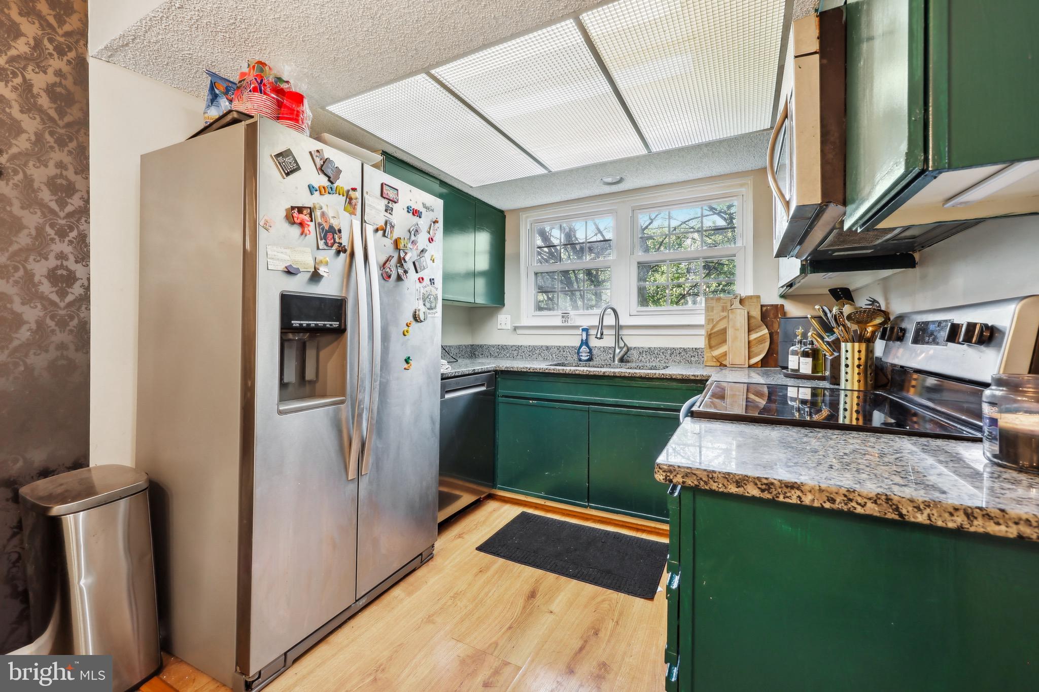 3805 Green Ridge Court, Unit 201 Fairfax, VA 22033 - Photo 10 of 25 a kitchen with stainless steel appliances granite countertop a refrigerator a sink and a stove
