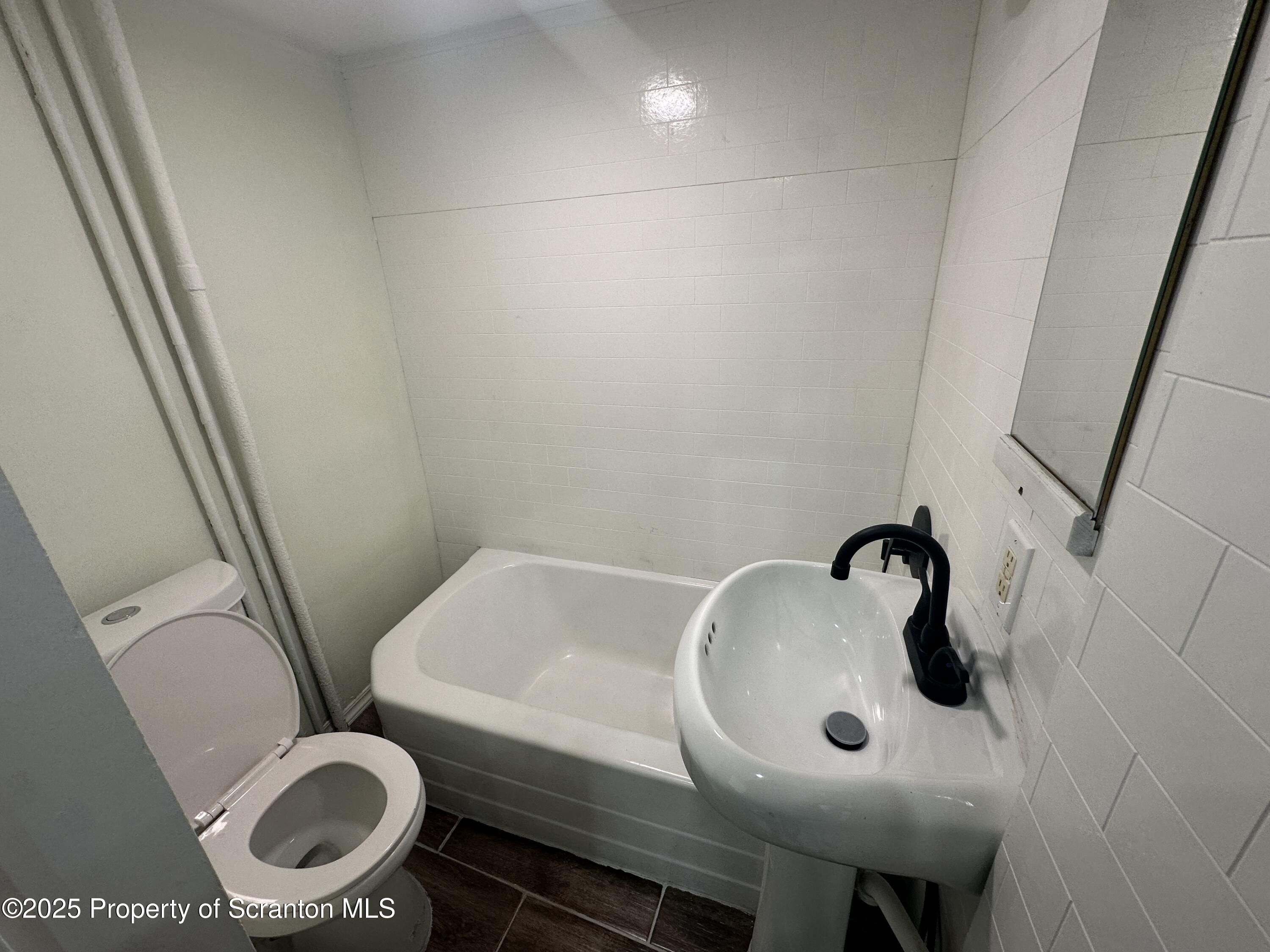 1262 South 6th Avenue Scranton, PA 18504 - Photo 6 of 8 a bathroom with a sink and toilet