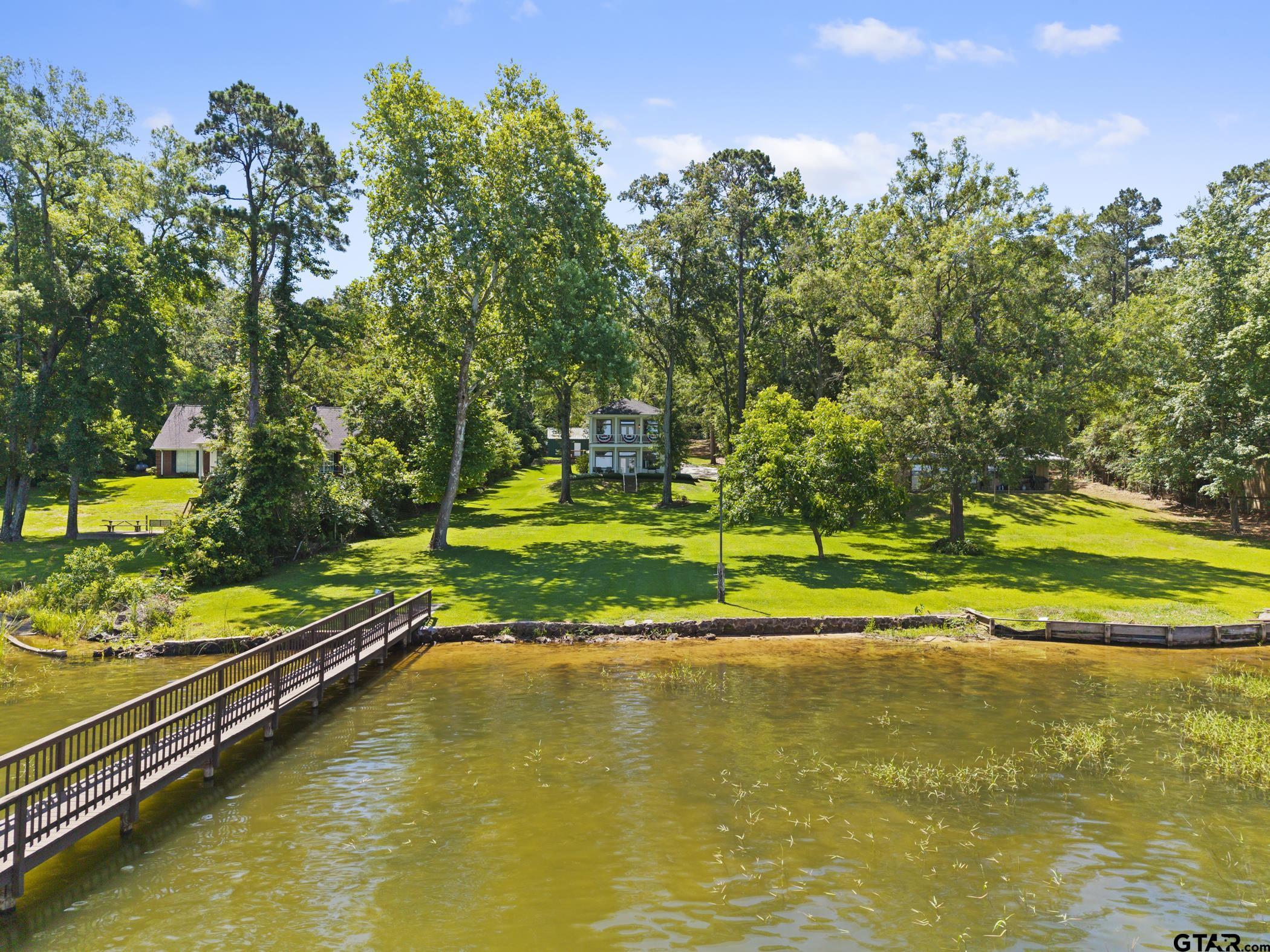 18630 Eastside Road Troup, TX 75789 - Photo 33 of 47 a view of a swimming pool with lawn chairs and plants