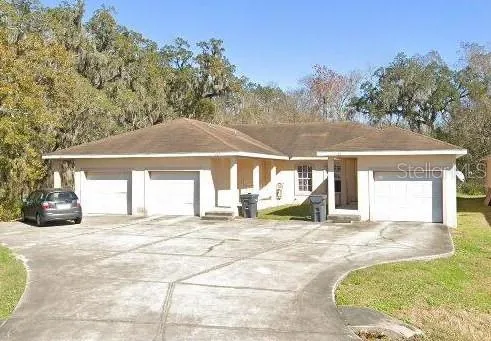 a view of a house with a yard and garage