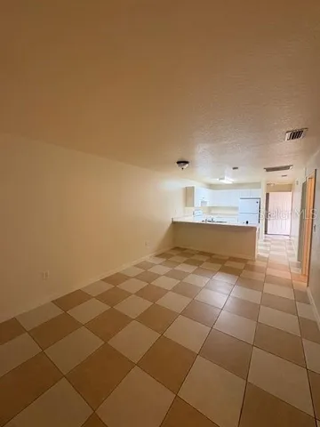 a view of empty room with wooden floor and cabinet