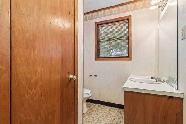 a bathroom with a sink a vanity and a mirror