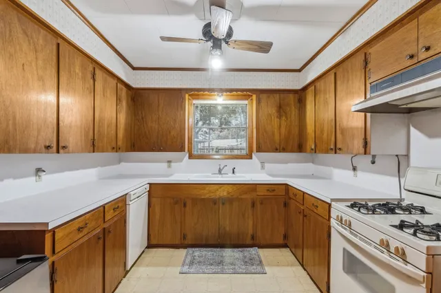 a kitchen with a sink stove and cabinets