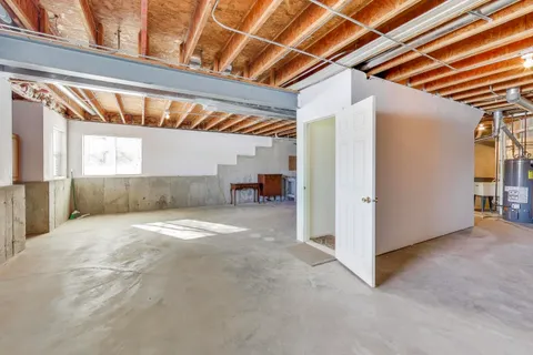 a view of empty room with wooden floor and door