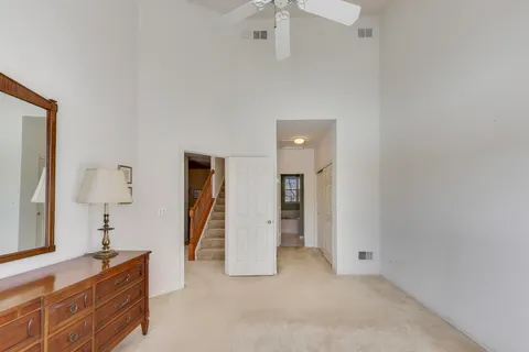 an empty room with closet and mirror