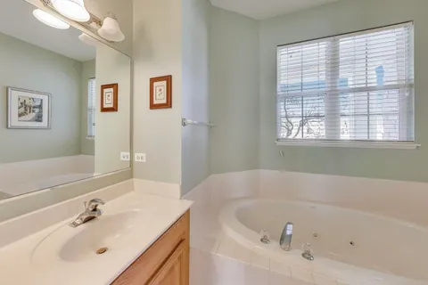a white bath tub sitting next to a white sink