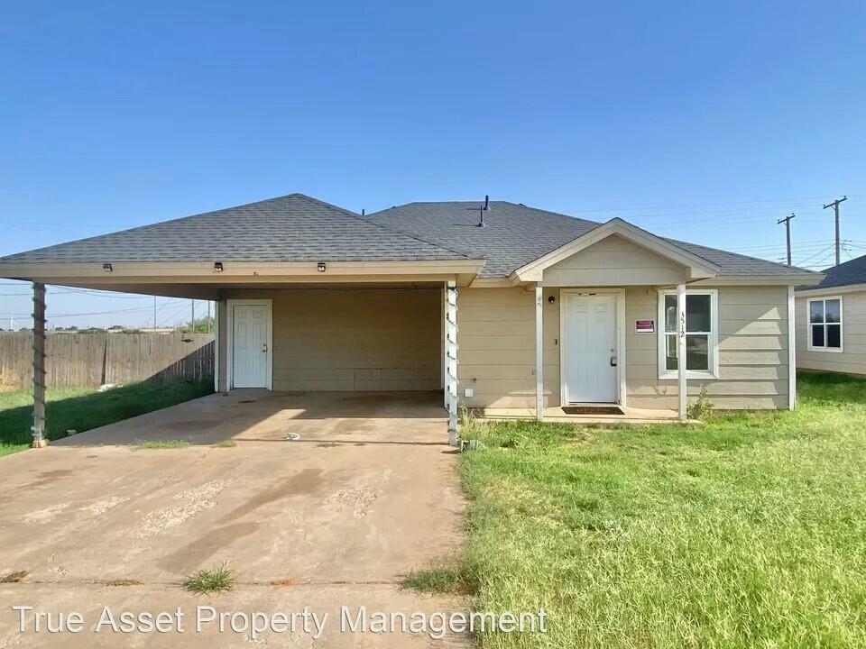 3508 East Colgate Street Lubbock, TX 79403 - Photo 12 of 38 a front view of a house with a yard and garage