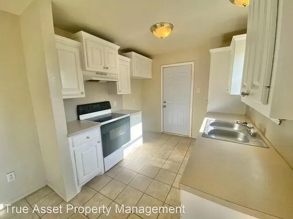 a kitchen with stainless steel appliances a sink and a stove