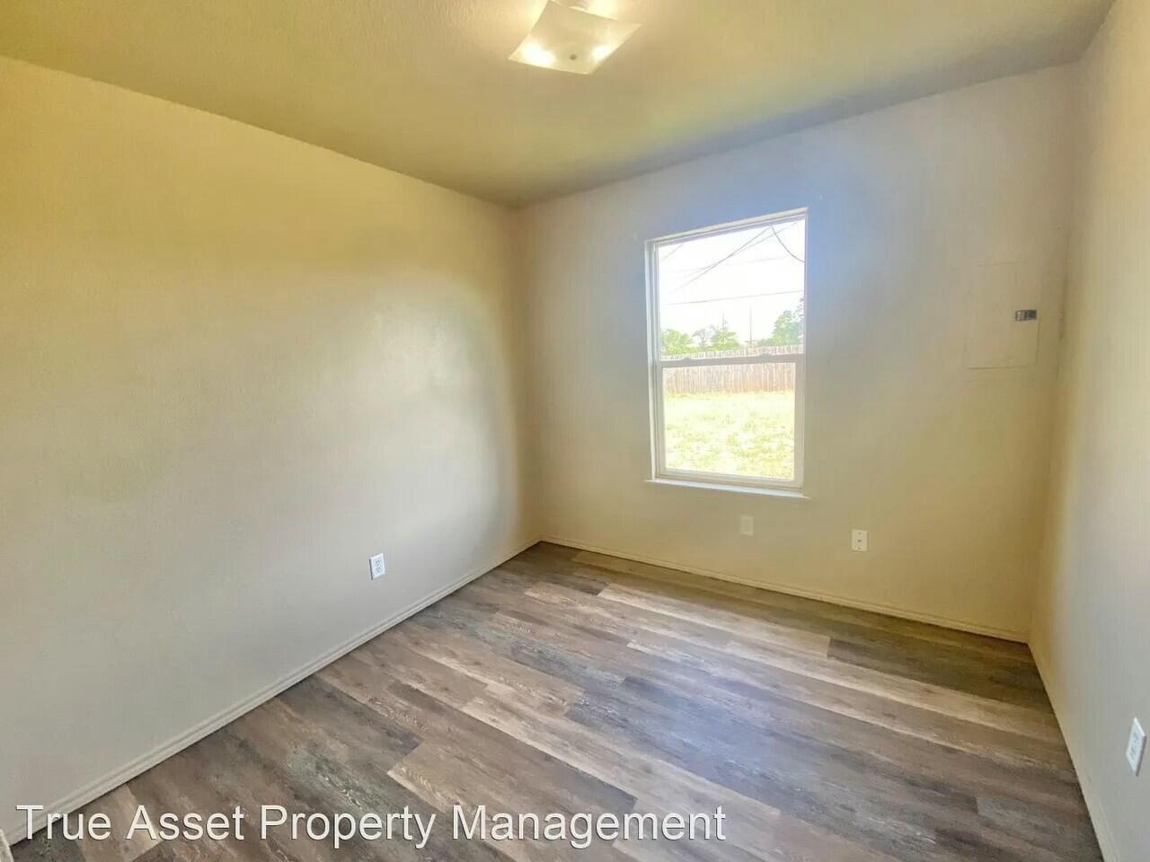 3508 East Colgate Street Lubbock, TX 79403 - Photo 18 of 38 a view of an empty room with wooden floor and a window