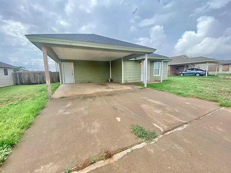 3508 East Colgate Street Lubbock, TX 79403 - Photo 2 of 38 a front view of a house with a garden and trees