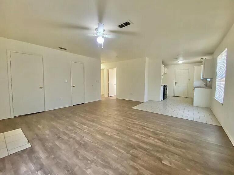 3508 East Colgate Street Lubbock, TX 79403 - Photo 26 of 38 a view of a big room with a chandelier fan and windows