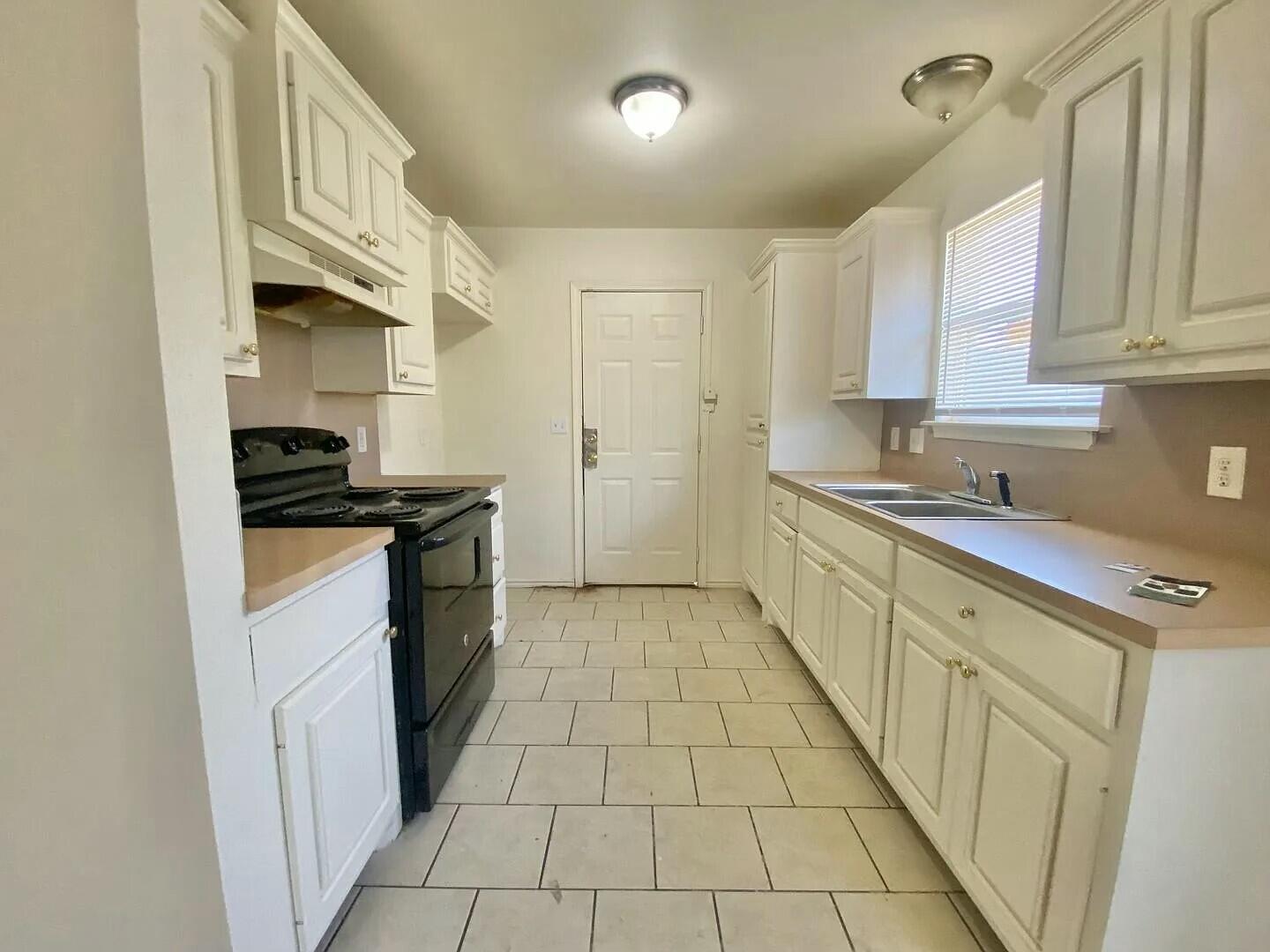 3508 East Colgate Street Lubbock, TX 79403 - Photo 27 of 38 a kitchen with stainless steel appliances a sink stove and cabinets