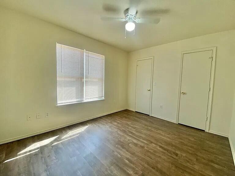 3508 East Colgate Street Lubbock, TX 79403 - Photo 32 of 38 an empty room with wooden floor cabinet and windows