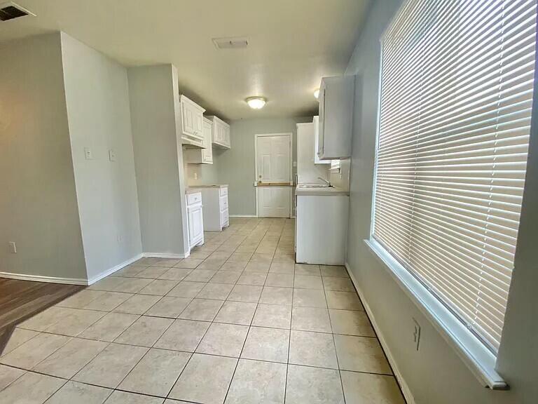 3508 East Colgate Street Lubbock, TX 79403 - Photo 5 of 38 a view of a kitchen with a sink and an empty room