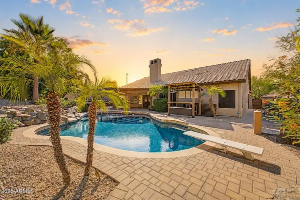 a swimming pool with outdoor seating and yard
