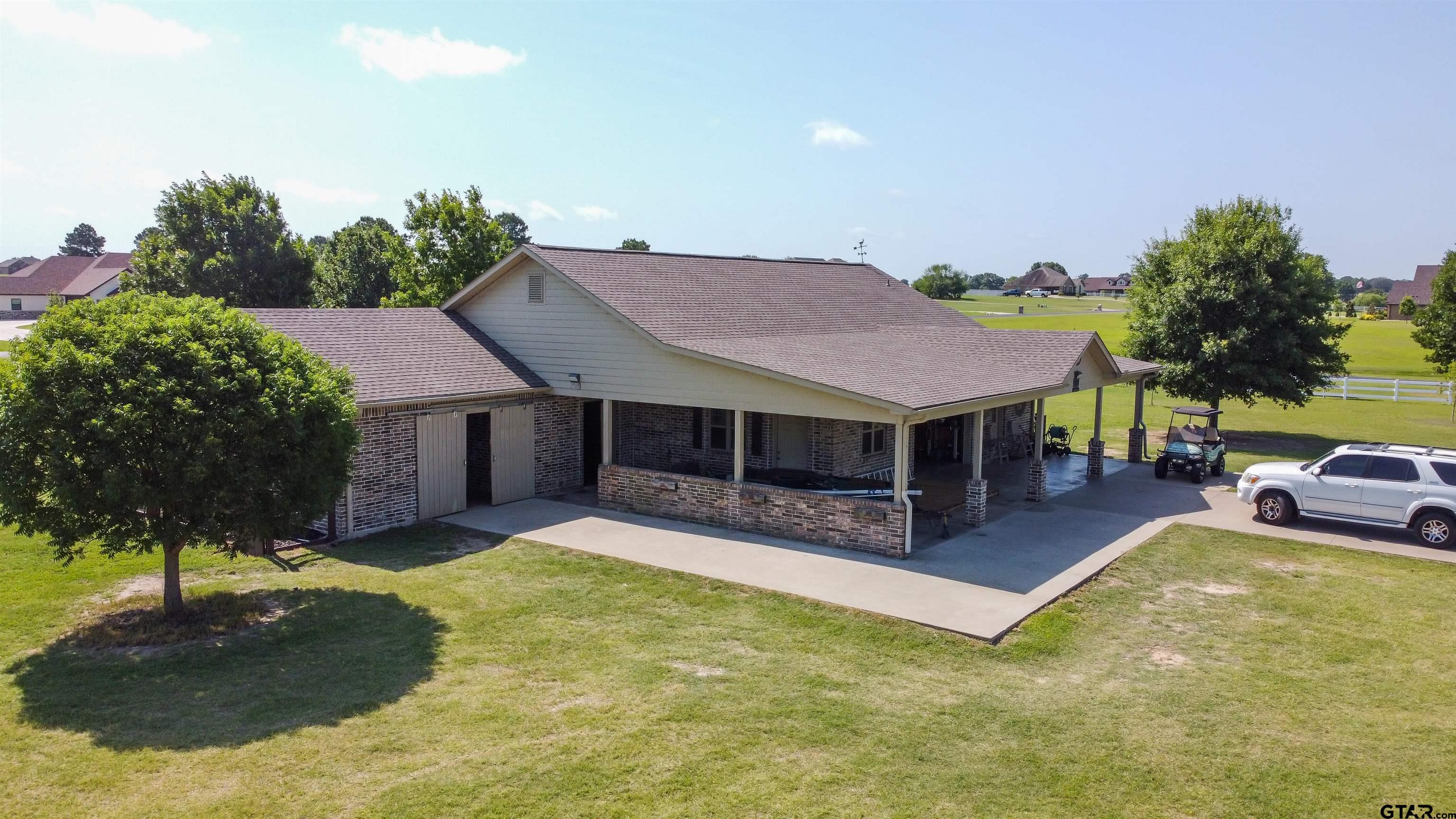 23120 Saddle Ridge Court Lindale, TX 75771 - Photo 29 of 34 a view of a house with swimming pool and sitting area