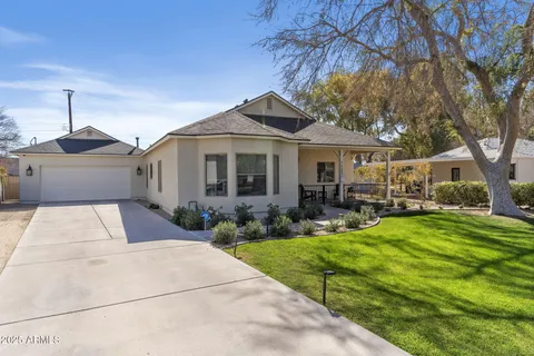 a front view of a house with yard patio and green space