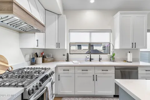 a kitchen with a sink stove and cabinets