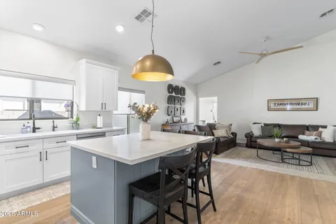 a large kitchen with a table and chairs