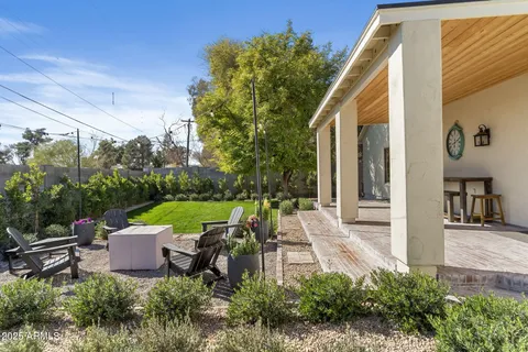 a view of a patio with table and chairs and potted plants