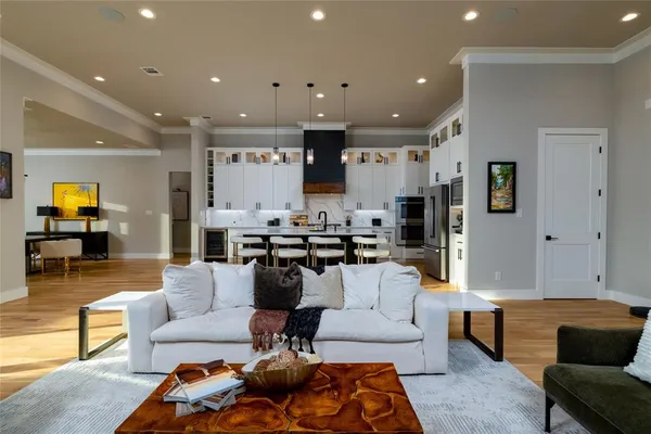a living room with furniture and kitchen view