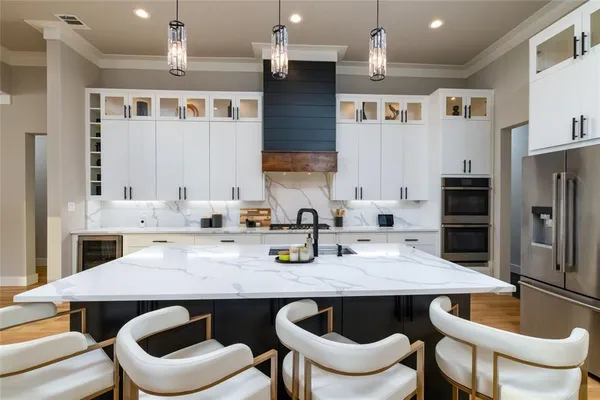 a kitchen with granite countertop a dining table and chairs