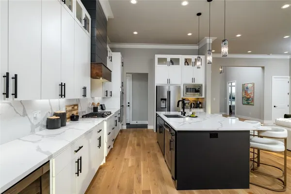 a large kitchen with kitchen island a sink counter space and stainless steel appliances