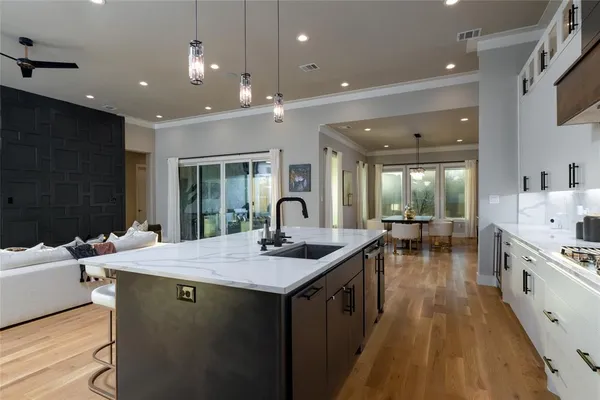 a kitchen with sink stove and cabinets