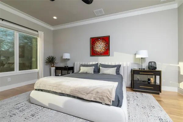 a spacious bedroom with a bed and a large window