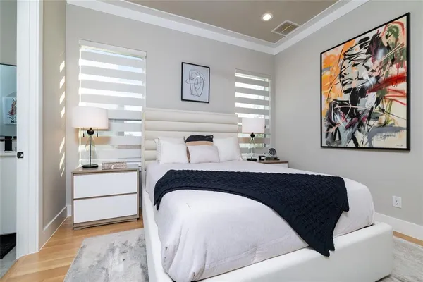 a bedroom with a bed and wall painting