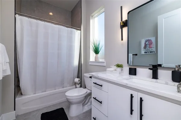 a bathroom with a toilet a sink and a bath tub