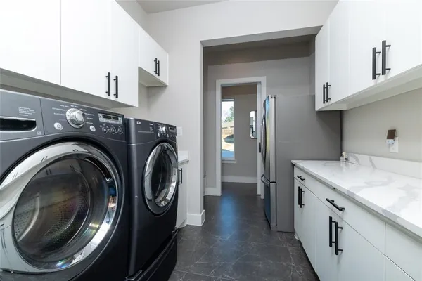 a utility room with sink dryer and washer