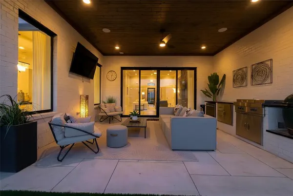 a living room with couches and furniture with kitchen view