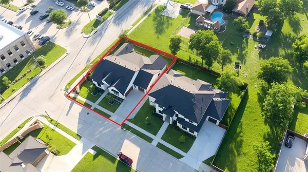 an aerial view of a house with a yard