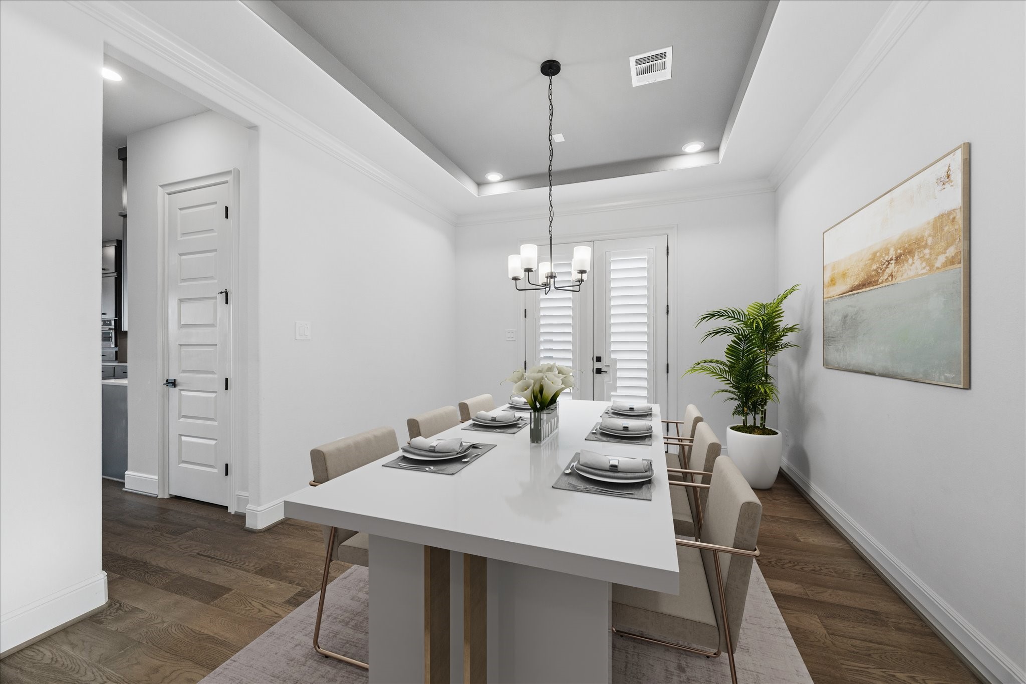 28015 Royal Swan Lane Spring, TX 77386 - Photo 13 of 25 Elegant dining room with tray ceiling, designer chandelier, and rich wood flooring. Conveniently located adjacent to the butler’s pantry for seamless entertaining. *Virtually Staged